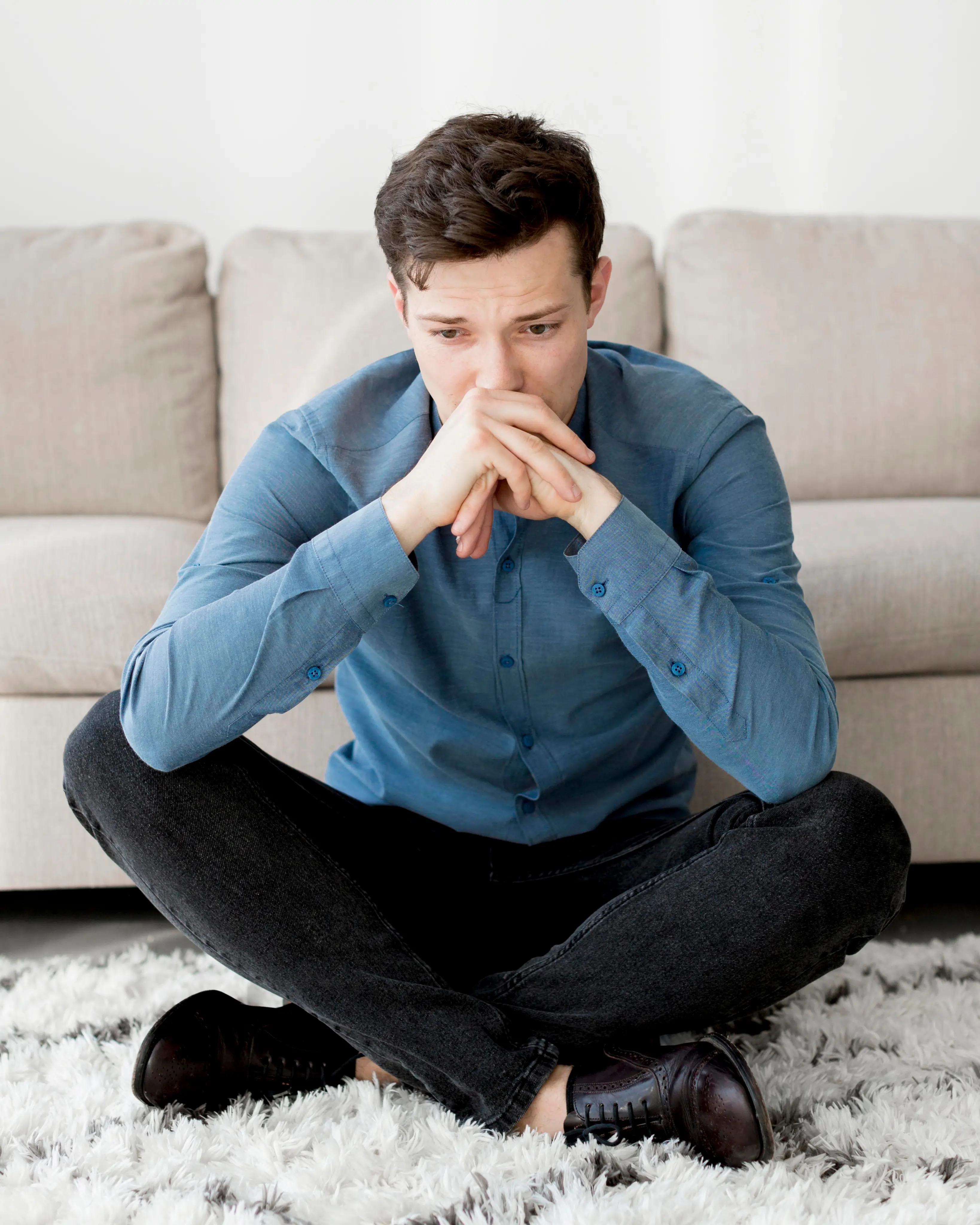 Worried man sitting on the floor